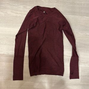 Burgundy Lululemon long sleeve running shirt.